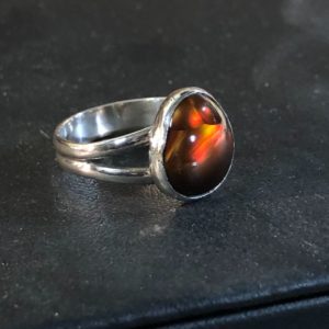 Fire Agate ring on a black surface.