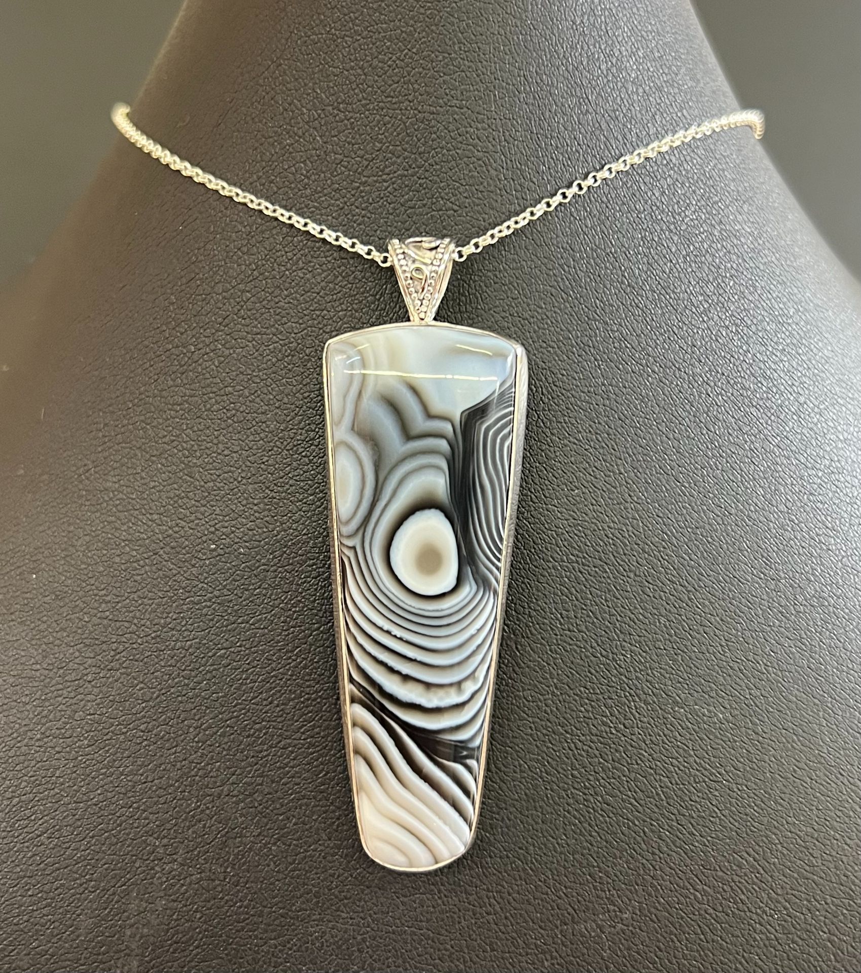 Black and white pendant on a black display.