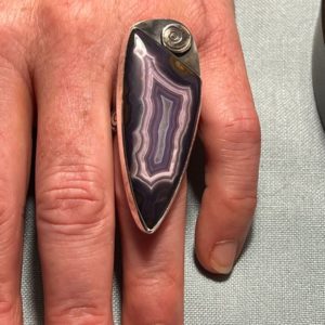 Purple Passion ring on a persons ring finger.