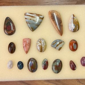 Assortment of cabochons on a tan foam.