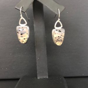 Montana Moss earrings on a black display stand.